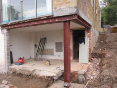 an unfinished house with stairs leading up to it