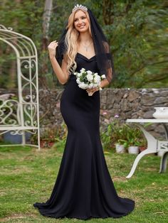 a woman in a black dress holding a bouquet