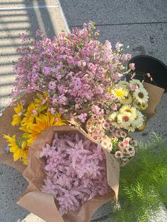 a bouquet of flowers sitting on top of a sidewalk