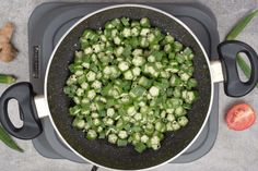 green vegetables are being cooked in a skillet