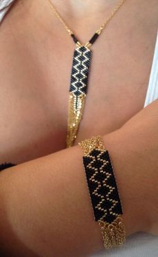 a woman wearing a black and gold bracelet