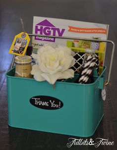 a teal container filled with items on top of a table