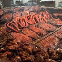 steaks and hot dogs are being grilled on the grill