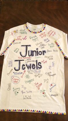 a white t - shirt with the words junior jewels written all over it on it