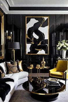 a living room with black walls, gold accents and white couches in front of a painting