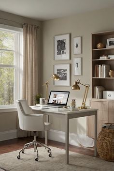 a desk with a laptop computer on it in front of a window and bookshelf