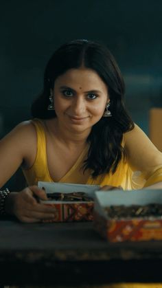 a woman sitting at a table with some food in front of her