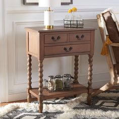 a wooden table sitting next to a chair on top of a rug