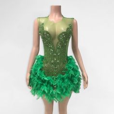 2-3 weeks processing and shipping time This hand beaded mini dress features a beautiful, beaded bodice and a feathered bottom. The color coordinated back is a stretchy spandex material. If you want coverage in those special areas, Spanx, a bra, underwear, a slip or whatever you choose can be worn underneath! Color may vary due to lighting Material: polyester, elastane Care: hand wash or dry clean only Fitted Mini Length Flapper Dress For Club, Glamorous Fitted Flapper Dress With Feather Trim, Fitted Green Embellished Mini Dress, Fitted Embellished Green Mini Dress, Feather Trim Mini Dress For Costume Party, Fitted Feathered Flapper Dress, Fitted Feather Trim Flapper Dress For Night Out, Fitted Flapper Dress With Feather Trim For Night Out, Fitted Green Flapper Dress For Party