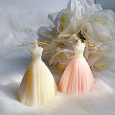 two brides dresses are sitting next to each other on a white furnishing