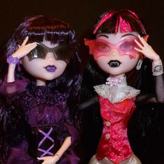 two dolls are dressed up and posing for the camera