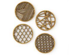 four round wooden pieces with geometric designs on the sides, all in different shapes and sizes