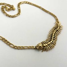 The Centipede Girl Necklace is as creepy and cute as it gets. Available in silver or gold tone, this necklace is sure to instill the back-off vibes that you might want to illicit on an especially dark day, to keep the real creeps away. Details below!Dimensions:The centipede girl measures 2.75 inches long and half of an inch wide. The chain is adjustable, measuring 16" at its shortest and 17 inches at its longest.Materials:Silver Tone: White brass charm on a silver tone chain.Gold Tone: Brass cha Gothic Gold Necklace With Adjustable Chain, Gothic Gold Necklace With Clavicle Chain, Gold Punk Necklace For Halloween, Gold Metal Necklace For Halloween, Gold Punk Necklace With Adjustable Chain, Edgy Gold Necklace For Gifts, Edgy Gold Necklace For Gift, Gold Punk Clavicle Chain Necklace, Creepy Cute Fashion