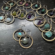 Now that I offer so many Crystal and Stone options, I decided to condense this particular line of my "Tiny" sized hoops with Crystals or Stones into just 2 listings- one for all of the Brass Hoop options and one for all of the Sterling Silver Hoop options!THIS LISTING IS FOR ALL OF THE BRASS HOOP OPTIONS: Here you can select the pair of Crystals or Stones you'd like to have framed within! Each is carefully wire-wrapped to be suspended in the centers of the hoops, and all of these hang from Sterl Mod Earrings, Popular Necklaces, Popular Earrings, Wire Wrapped Jewelry Diy, One For All, Brass Hoops, Wholesale Gifts, Gold And Silver Rings, Feather Necklaces