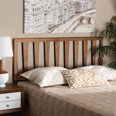 a bedroom with a bed, nightstand and painting on the wall above it's headboard