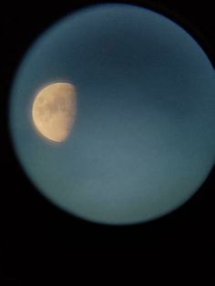 the moon is seen through a telescope lens