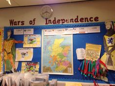 a bulletin board with flags and posters on it that says wars of indecence