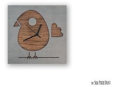 a wooden clock with a bird design on it's face and two hearts in the middle