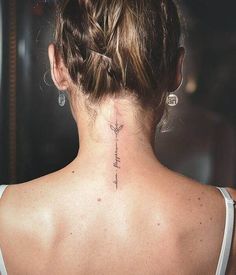 a woman with a tattoo on her back neck