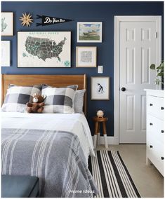 a bed room with a neatly made bed and pictures on the wall