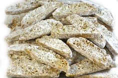 a pile of dog treats sitting on top of a white tablecloth covered in powdered sugar