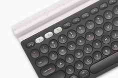 a computer keyboard sitting on top of a white table