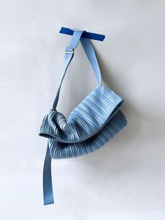 a piece of cloth hanging on a wall with a tie around it's neck