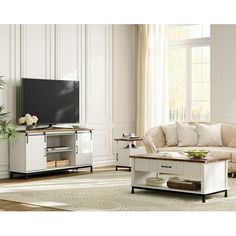 a living room filled with furniture and a flat screen tv on top of a stand