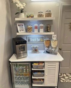 a snack bar with lots of food and drinks on the shelves in front of it