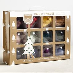 the box contains six pairs of socks in different colors and designs, including a christmas tree