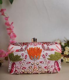 Elevate your evening look with this elegant clutch bag for women, perfect for weddings, parties, or formal events. Handmade with luxurious exterior in a vibrant odaek green hue, this clutch features a convenient clasp closure and a chain for easy carrying. The ethnic theme adds a touch of cultural charm, making it a versatile accessory for both casual and dressy occasions. Add this unique piece to your collection for a stylish statement. Designer Multicolor Clutch For Party, Designer Party Pouch Box Bag, Designer Pouch Box Bag For Party, Designer Clutch Box Bag For Party, Bollywood Style Party Pouch With Zari Work, Elegant Bag With Mirror Work For Diwali, Bollywood Party Pouch With Zari Work, Designer Pink Clutch For Party, Pink Bag For Formal Festive Occasions