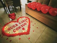 a heart - shaped sign that says, outer cash comics on the floor next to some red balloons