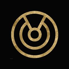 a gold circle with an arrow in the center on a black background that says,