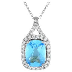 A brilliant blue Blue Topaz gemstone makes a statement on this impeccably crafted luxury necklace. This pieces pendant is crafted from 14K White Gold and measures 0.75 long by 0.45 wide. Its suspended from an 18 chain and includes sparkling Diamond accents with a total weight of 0.13 carats.This jewelry piece is offered in brand new condition and includes a gift box. Formal Blue Diamond Gemstone Necklace, Formal Blue Gemstone Diamond Necklace, Blue Diamond Cut Necklace In Fine Jewelry Style, Blue Diamond Cut Fine Jewelry Necklace, Elegant Turquoise Necklace With Diamond Accents, Elegant Turquoise Necklaces With Diamond Accents, Luxury Diamond Necklace With Accent Stones, Blue Gemstone Diamond Necklace In Fine Jewelry Style, Blue Gemstone Diamond Necklace, Fine Jewelry