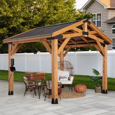 a wooden gazebo sitting in the middle of a yard