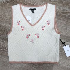 This Is A Super Cute Cream Colored Cropped Sweater Vest With A Light Pink/Beige Trim. Embroidered Florals Under The V-Neck. 8% Wool Blend. From The Forever 21 Premium Collection. Size Medium. Brand New With Tags! From Shoulder To Bottom Of Vest Is 19 Inches Tags Eclectic Grandpa, Lagenlook, Floral, Girly, Sweater Vest, Coastal Grandma, Boho, Prairie, Feminine, Neutral, Embroidered Grandma Vest, Girly Sweater, Cropped Sweater Vest, Beige Trim, Eclectic Grandpa, Coastal Grandma, Forever 21 Sweater, Embroidered Sweater, Pink Beige