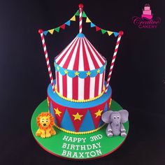 a circus themed birthday cake with an elephant and giraffe