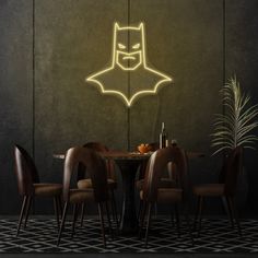 a dining room with a batman neon sign above the table