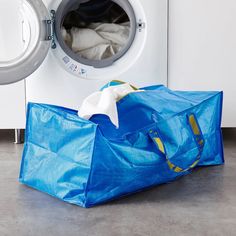 a blue bag sitting next to a washing machine