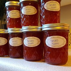 several jars of jam sitting on top of a table