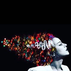 a woman with christmas lights on her head and hair in the shape of an x - ray