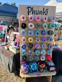 there are many different types of donuts on display at this market stall that is selling them