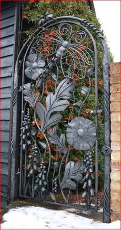 an iron gate with flowers and vines on it