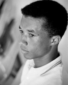 a young man looking at his reflection in the mirror