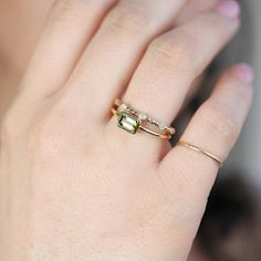 a woman's hand with a ring on it and a yellow diamond in the middle