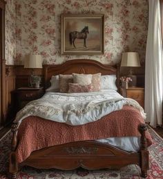 a bedroom with floral wallpaper and an old fashioned bed in the corner, along with two lamps on either side of the bed