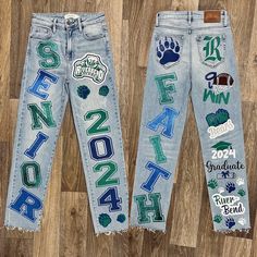 two pairs of jeans with the letters and numbers painted on them