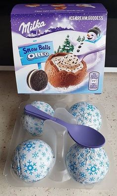 an ice cream box with six snow balls and a spoon