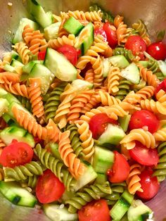 a bowl filled with pasta salad and cucumbers