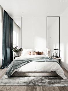 a large white bed sitting in a bedroom on top of a hard wood floor next to a window